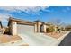 Charming single-story home featuring a two-car garage, desert landscaping, and a welcoming facade at 5468 Carrara Pointe St, Pahrump, NV 89061