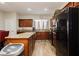 Functional kitchen featuring wood cabinets, a granite island, stainless steel appliances, and wood flooring at 5468 Carrara Pointe St, Pahrump, NV 89061