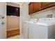 Functional laundry room with washer and dryer, and plenty of space for storage and sorting at 5468 Carrara Pointe St, Pahrump, NV 89061