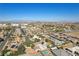 Expansive aerial view of a neighborhood with houses, pools, and city skyline in the distance at 5625 W Agate Ave, Las Vegas, NV 89139