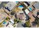 Aerial view of a neighborhood featuring single-Gathering homes, fenced yards, desert landscaping, and community swimming pools at 5625 W Agate Ave, Las Vegas, NV 89139