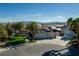 Aerial view of a single-story house with a large yard and palm trees at 5625 W Agate Ave, Las Vegas, NV 89139