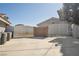 Fenced backyard space with a driveway, offering privacy and security, with view of the home's roof at 5625 W Agate Ave, Las Vegas, NV 89139