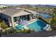 Private backyard oasis featuring a refreshing pool, patio area, and serene water views at 5625 W Agate Ave, Las Vegas, NV 89139