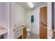 Simple bathroom featuring a utility sink with wooden drawers, toilet, and a towel rack, showcasing functionality at 5625 W Agate Ave, Las Vegas, NV 89139