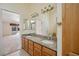 Bathroom vanity with double sinks and granite countertop, next to an open doorway at 5625 W Agate Ave, Las Vegas, NV 89139