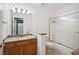 Well-lit bathroom features a single sink vanity, tiled floors, and a shower with a glass door at 5625 W Agate Ave, Las Vegas, NV 89139