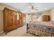 Bedroom featuring detailed wooden furniture, ceiling fan, and warm natural light, creating a comfortable and inviting space at 5625 W Agate Ave, Las Vegas, NV 89139