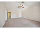 Large bedroom featuring neutral paint, carpet flooring, and an exit sliding glass door at 5625 W Agate Ave, Las Vegas, NV 89139