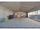 Spacious metal carport with concrete base, offering covered parking and room for storage on a gravel lot at 5625 W Agate Ave, Las Vegas, NV 89139