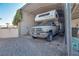 Carport with an RV and metal structure, providing ample sheltered parking and storage at 5625 W Agate Ave, Las Vegas, NV 89139