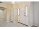 Bright entryway features tile flooring, a decorative front door with sidelights, and neutral paint at 5625 W Agate Ave, Las Vegas, NV 89139