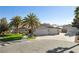 Charming single-story home with mature palm trees, three-car garage, and well-maintained landscaping at 5625 W Agate Ave, Las Vegas, NV 89139