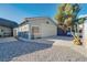 Detached garage with gravel driveway and mature landscaping at 5625 W Agate Ave, Las Vegas, NV 89139