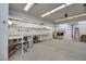 Spacious garage interior featuring bright lighting, workbench area, and concrete flooring at 5625 W Agate Ave, Las Vegas, NV 89139