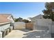 Exterior view of a detached two-car garage featuring gray walls, a block fence, and a gated area at 5625 W Agate Ave, Las Vegas, NV 89139