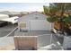 Exterior view of a detached two-car garage featuring white doors, gray walls, and a gated area at 5625 W Agate Ave, Las Vegas, NV 89139