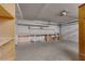 Functional garage space equipped with built-in shelving and a storage area, illuminated by overhead lighting at 5625 W Agate Ave, Las Vegas, NV 89139