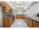 Well-lit kitchen with granite countertops, tile flooring, and wooden cabinets at 5625 W Agate Ave, Las Vegas, NV 89139