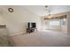 Living room features a ceiling fan, carpet, and large window offering ample natural light and comfort at 5625 W Agate Ave, Las Vegas, NV 89139