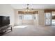 Bright living room with beige carpet, bay window, and sliding door access to the backyard at 5625 W Agate Ave, Las Vegas, NV 89139