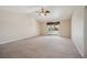 Vast living room featuring neutral paint, carpet flooring, and sliding glass door access to the backyard at 5625 W Agate Ave, Las Vegas, NV 89139