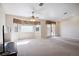 Bright living room with carpet, ceiling fan, and natural light from windows and sliding glass doors at 5625 W Agate Ave, Las Vegas, NV 89139