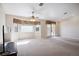Bright living room featuring neutral paint, vaulted ceiling, and a sliding glass door to the backyard at 5625 W Agate Ave, Las Vegas, NV 89139