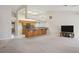 Spacious living room with carpeted floors and an open layout to the kitchen area at 5625 W Agate Ave, Las Vegas, NV 89139
