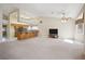 Inviting living room with vaulted ceiling flowing seamlessly into the kitchen with bar seating at 5625 W Agate Ave, Las Vegas, NV 89139