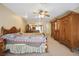 Bedroom with a full bedroom set including an armoire, bed, and vanity at 5625 W Agate Ave, Las Vegas, NV 89139