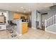 Eat-in kitchen featuring wooden cabinetry, stainless steel appliances, and a breakfast bar at 6356 Blue Twilight Ct, Las Vegas, NV 89108