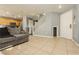 Spacious living room featuring tile floors, a cozy sofa, and a stairway to the second floor at 6356 Blue Twilight Ct, Las Vegas, NV 89108