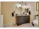 Elegant bathroom with dark vanity and marble floors at 6520 Brushwood Ln, Las Vegas, NV 89107