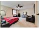 Spacious Primary bedroom with a red comforter and black furniture at 6520 Brushwood Ln, Las Vegas, NV 89107