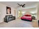 Bright bedroom featuring a cozy couch and large artwork at 6520 Brushwood Ln, Las Vegas, NV 89107