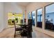 Dining area with black table and chairs, and kitchen views at 6520 Brushwood Ln, Las Vegas, NV 89107