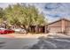 Brick house with a two-car garage and mature landscaping at 6520 Brushwood Ln, Las Vegas, NV 89107