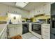 Kitchen with white cabinets and black appliances at 6520 Brushwood Ln, Las Vegas, NV 89107