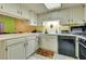 Bright kitchen features white cabinets, black appliances, and yellow walls at 6520 Brushwood Ln, Las Vegas, NV 89107