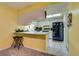 Galley kitchen with black appliances and yellow walls at 6520 Brushwood Ln, Las Vegas, NV 89107