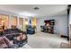 Living room with sectional sofa and large TV at 6520 Brushwood Ln, Las Vegas, NV 89107