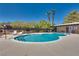 Community pool with surrounding lounge chairs at 6520 Brushwood Ln, Las Vegas, NV 89107