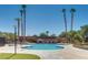 Circular community pool with surrounding lounge chairs at 6520 Brushwood Ln, Las Vegas, NV 89107