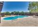 Kidney shaped community pool with lounge chairs at 6520 Brushwood Ln, Las Vegas, NV 89107