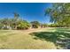 Large grassy yard with mature trees and a house at 6520 Brushwood Ln, Las Vegas, NV 89107