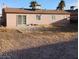 Backyard view with gravel landscaping and mature landscaping at 6741 Solaron Ave, Las Vegas, NV 89156