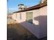 Backyard with a view of the exterior wall, windows, and an air conditioning unit at 6741 Solaron Ave, Las Vegas, NV 89156