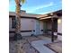 Covered front entrance featuring a security screen door and a xeriscaped yard at 6741 Solaron Ave, Las Vegas, NV 89156