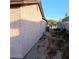 View of the side yard and the exterior wall of the house at 6741 Solaron Ave, Las Vegas, NV 89156